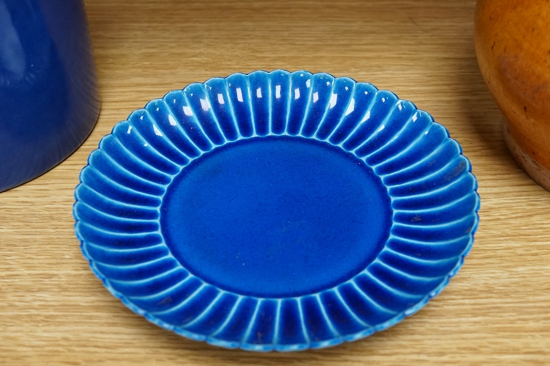 A Chinese blue glazed cylindrical brush pot, Kangxi mark but later, a similar saucer, Qianlong mark but later and a terracotta jug, 21cm
